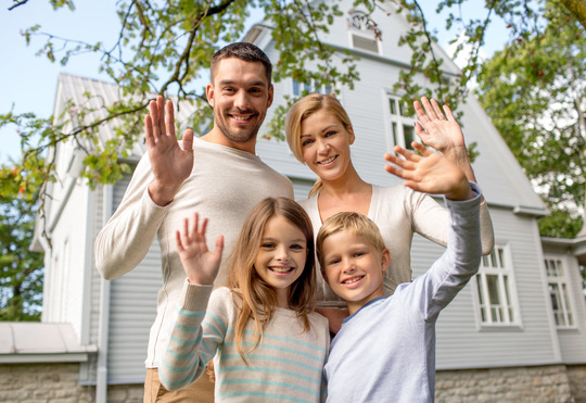 family in front of new home